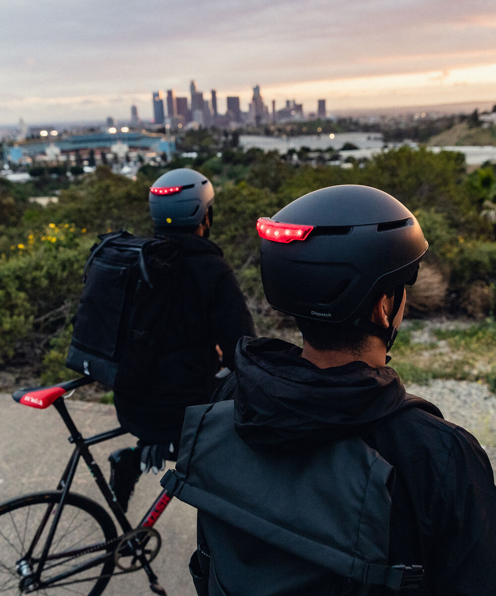 Cyclists overlooking city Cyclists overlooking city