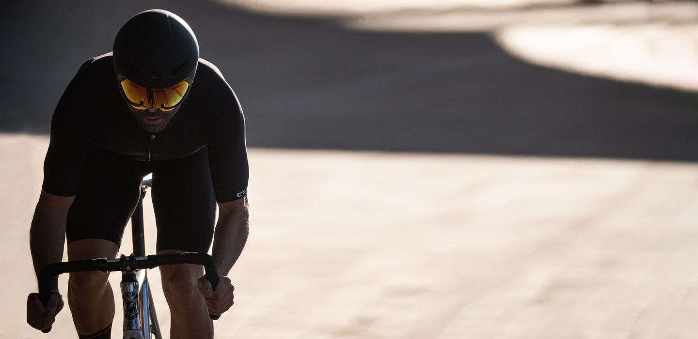 Cyclist wearing a time trial bike helmet on a road ride Cyclist wearing a time trial bike helmet on a road ride