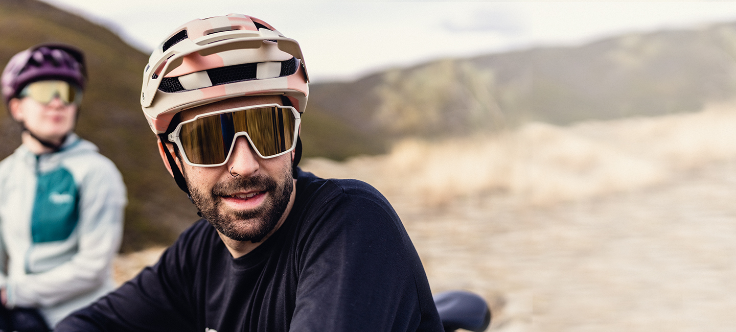 Man at trailhead wearing sunglasses